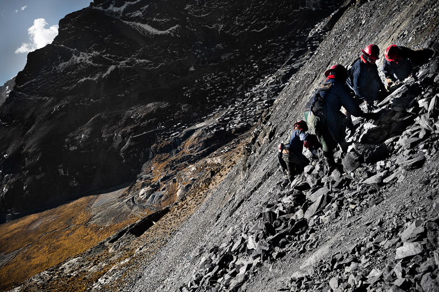 Pallaqueras, female gold miners, pick through the tailings, searching for gold around the gold mines in La Rinconada, Peru.