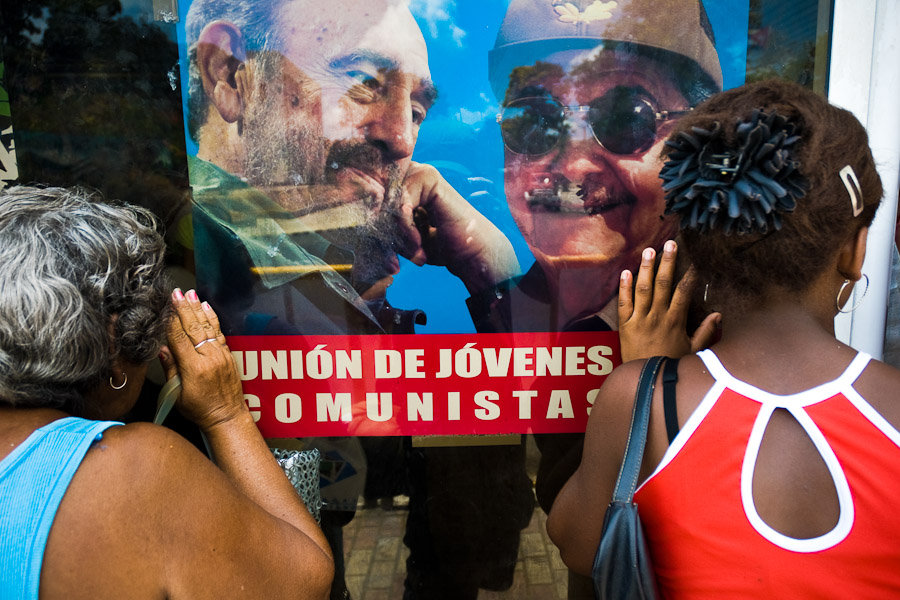 Cuban women look through a shop window. The state controlled and planned economy together with the US trade embargo caused the longtime shortage of food, consumer goods and services.