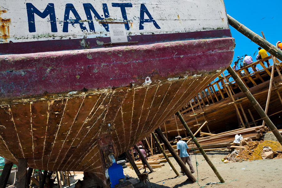The stern of a traditional fishing wooden vessel is seen being repaired in an artisanal shipyard on the beach in Manta, Ecuador.
