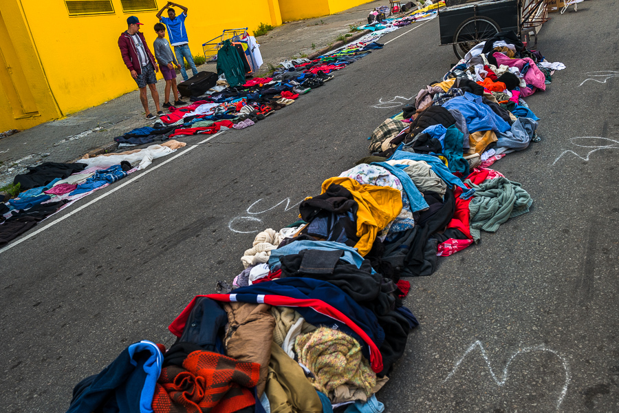 Uruguayan men look over a pile of secondhand clothes at the Tristán Narvaja street market in Montevideo, Uruguay.