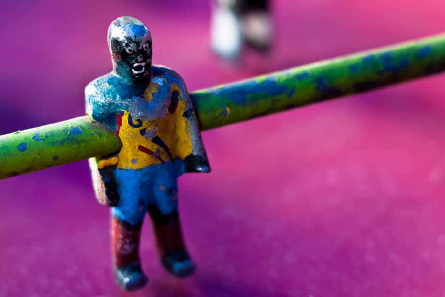 Table football player in yellow shirt, with peeled surface.