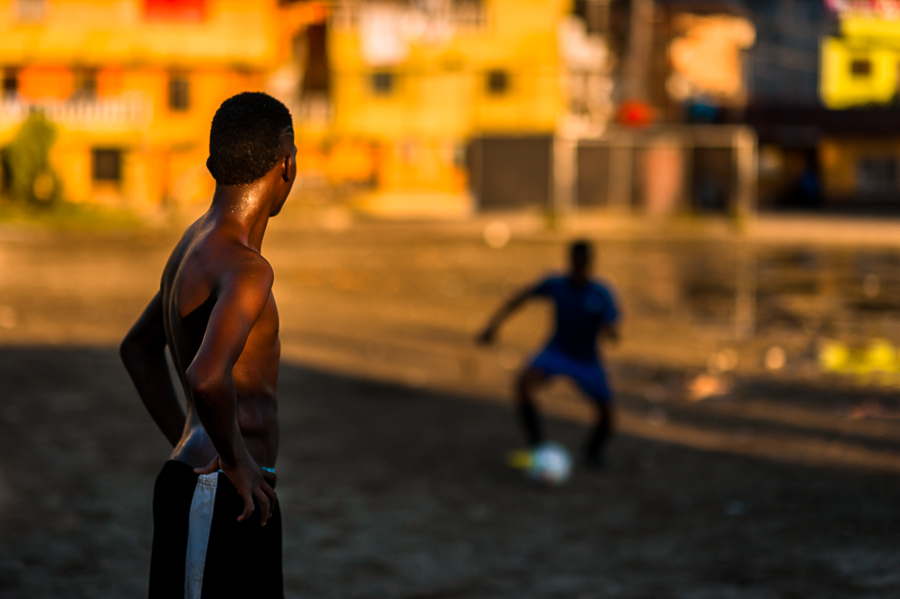 Afro-Colombian boys play football during the training session on a dirt field in Quibdó, Chocó, Colombia.