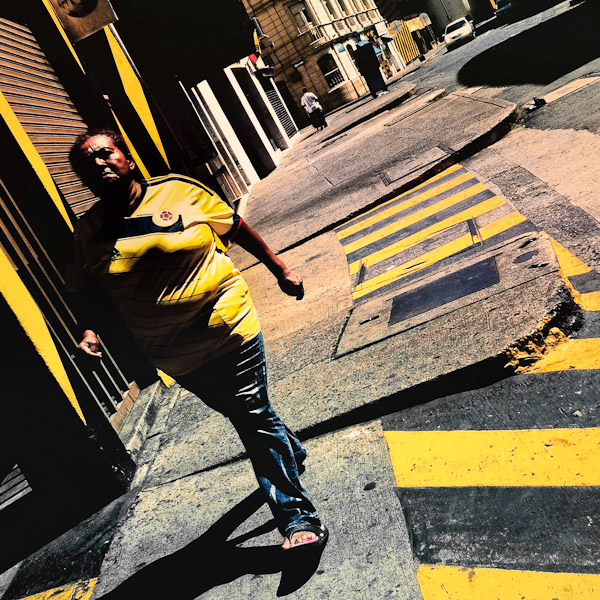 A Colombian woman, wearing the national football team t-shirt, walks on the street in Cali, Colombia.