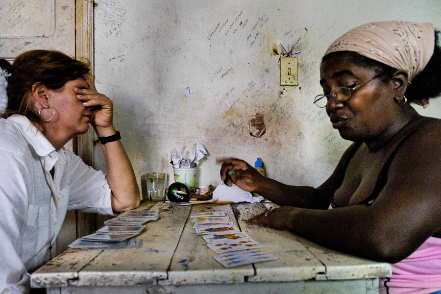A Cuban woman consults her health problem with a fortune teller, practitioner of a Afro-Cuban religion, in Santiago de Cuba, Cuba.