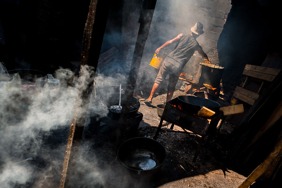 An Afro-Colombian cook fries fish in boiling oil at the market of Bazurto in Cartagena, Colombia.