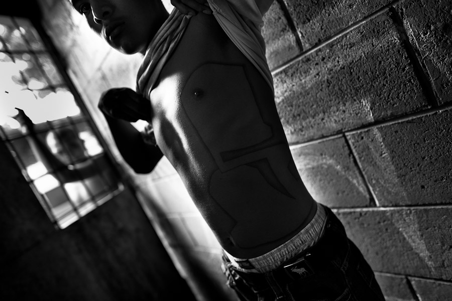 A member of the Mara Salvatrucha gang (“MS-13”) shows his tattoo in the prison, Tonacatepeque, El Salvador.