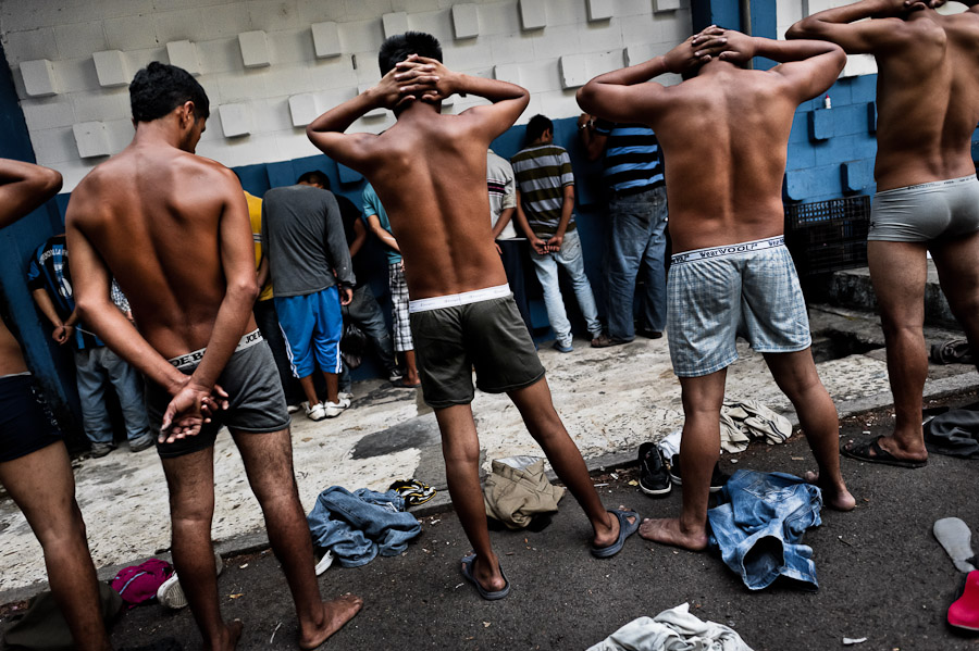 Alleged Mara gang members, detained by the Police emergency unit, pass through the initial search on the yard at the detention center in San Salvador, El Salvador.