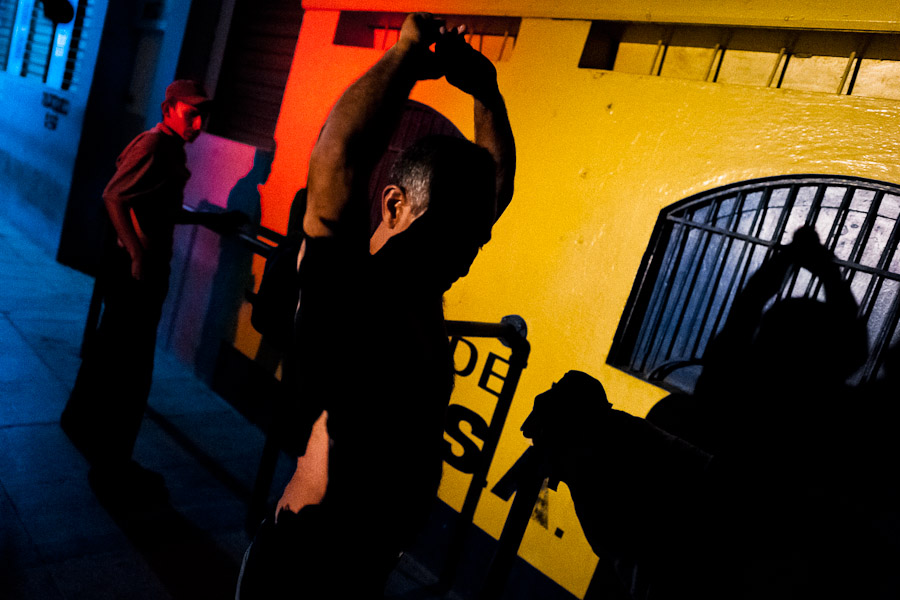 Gang members are controlled by the police officers from the special unit during the night in a gang neighbourhood of San Salvador, El Salvador.
