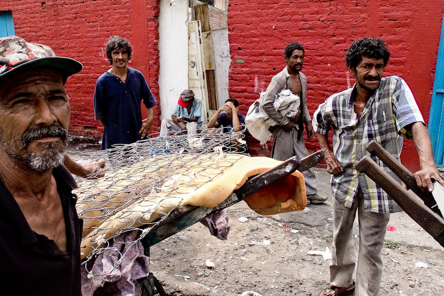 Garbage recollectors waiting on the street of El Calvario to sell found items to the metal buyer.