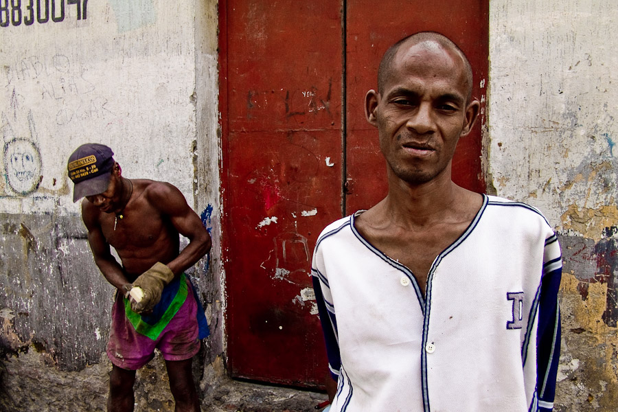 A Colombian slum dweller standing in front of a rented house in the ghetto of Calvario, Cali.