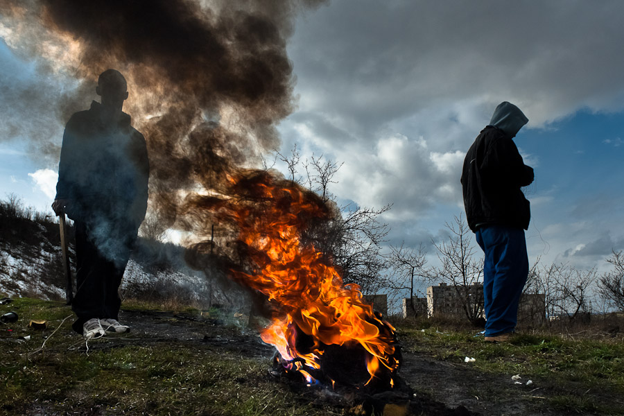 Young boys burn the used wires to recycle copper in the Gipsy ghetto of Chanov, Czech Republic.