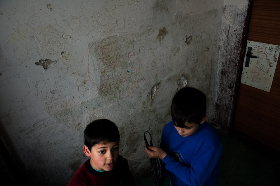 Gipsy boys knock on every door inside the slab block housing in Chánov.
