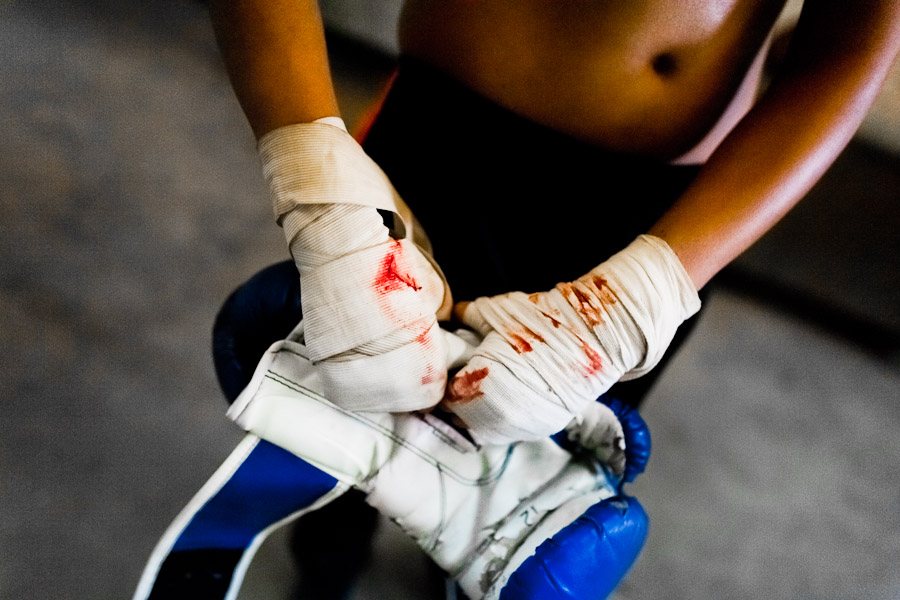 Geraldin Hamann's taped hands covered by blood are seen after a shadowboxing session in the boxing gym in Cali, Colombia.