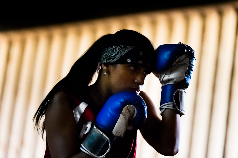 Geraldin Hamann, a young Colombian boxer, trains shadowboxing in the ring at a boxing club in Cali, Colombia.