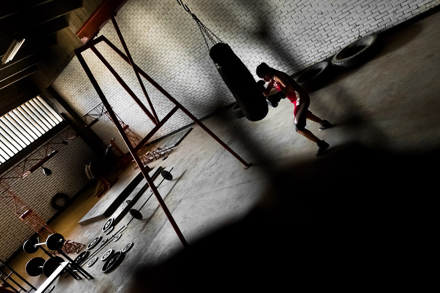 Geraldin Hamann, a young Colombian boxer, practices with punching bag in the boxing gym in Cali, Colombia.