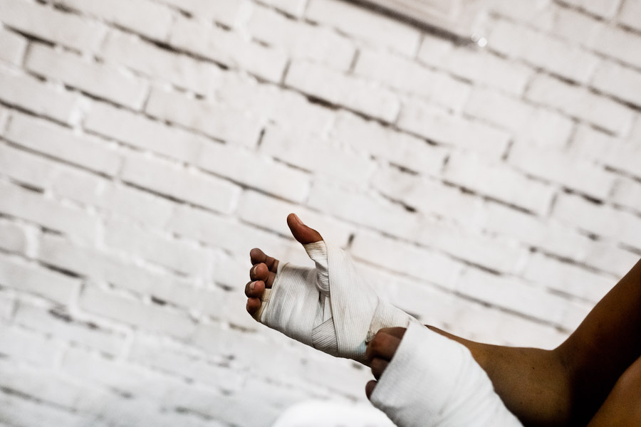 Geraldin Hamann, a young Colombian boxer, tapes her hands before a shadowboxing session in the boxing gym in Cali, Colombia.