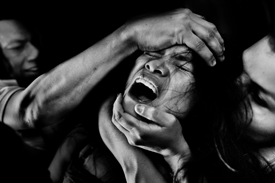 A Colombian girl screams of pain and fear while being allegedly possessed by demons during the exorcism ritual performed at a house church in Bogota, Colombia.