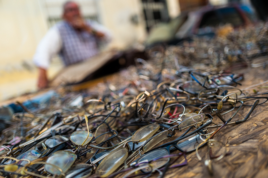 Dozens of old glasses and frames are seen piled up on a market stand table at the Tristán Narvaja street market in Montevideo, Uruguay.