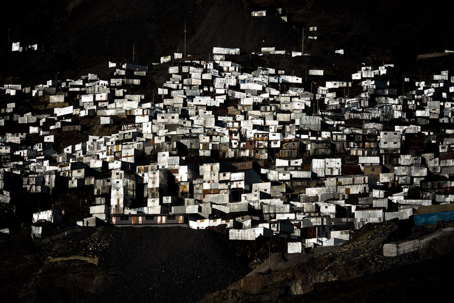 Corrugated metal shacks, homes of the gold miners, seen on a steep mountainside in La Rinconada, Peru.