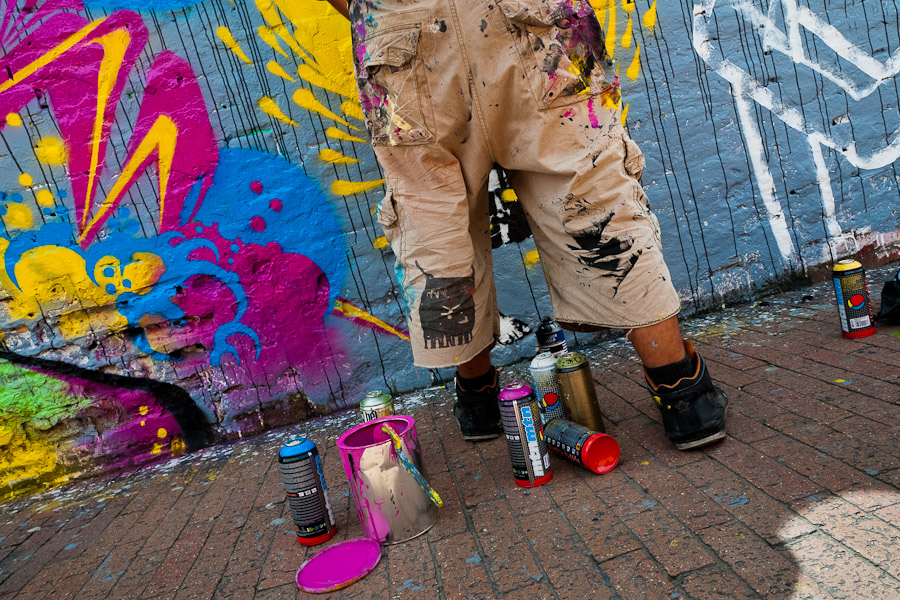 A Colombian street artist named Stinkfish paints graffiti on the wall in La Candelaria, Bogotá.