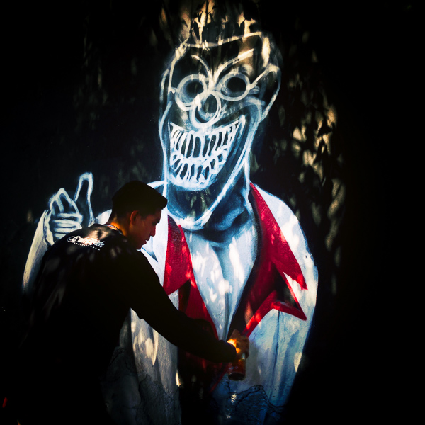 A Mexican street artist paints graffiti on the wall of a cemetery during a graffiti event in Guadalajara, Mexico.
