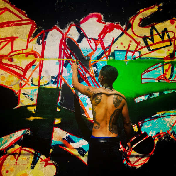 A Mexican street artist paints graffiti on the wall of a cemetery during a graffiti event in Guadalajara, Mexico.