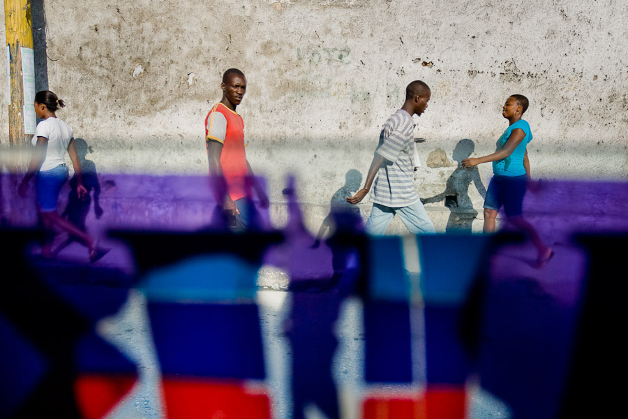 Haitian people on the street seen through the colourful tap-tap window in Pétionville, Port-au-Prince.