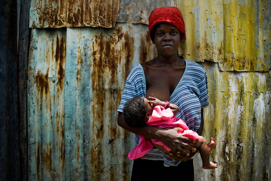 A young Haitian mother feeds her baby in the slum of Cité Soleil, Port-au-Prince, Haiti.