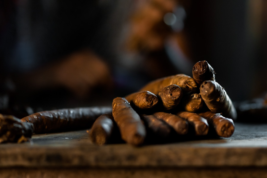 Hand rolled cigars are seen piled on the workbench of Laura Peña, a 67-years-old Salvadoran cigar maker, in Suchitoto, El Salvador.