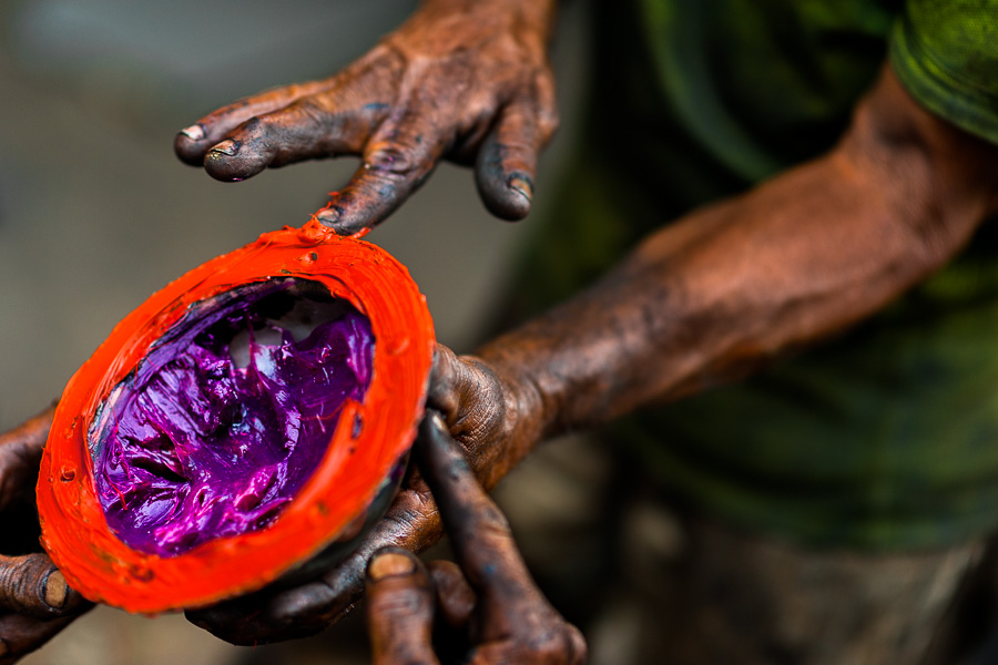 Colombian mechanics apply different types of lubricant grease on a truck axle cap during the maintenance service in Barrio Triste, Medellín, Colombia.