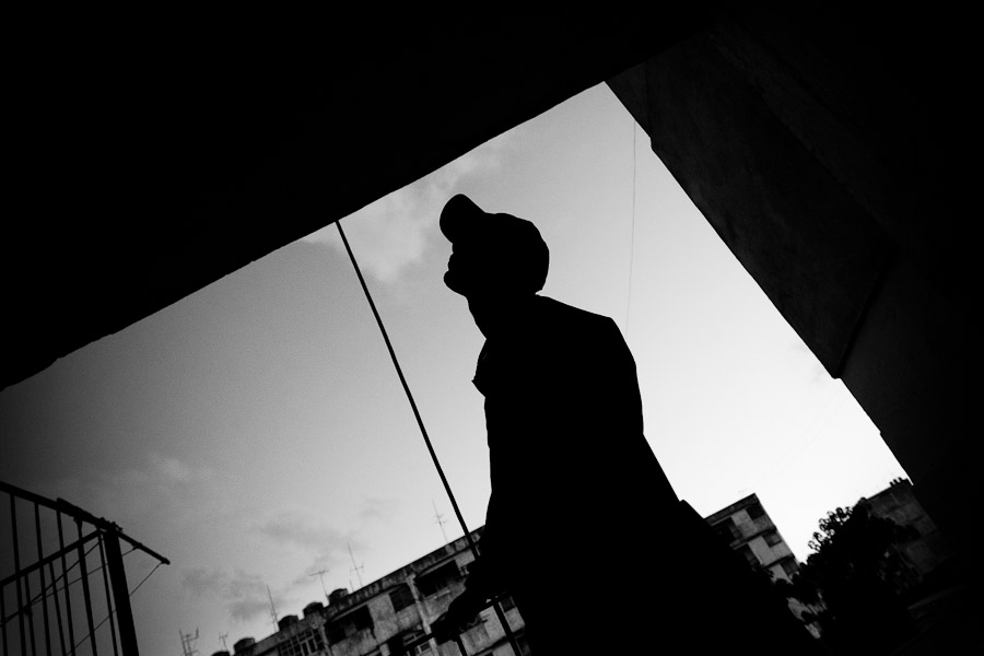 Jorge D., a Cuban hip-hop fan, walks out of the large apartment block of Alamar, a public housing suburb of Havana, Cuba.