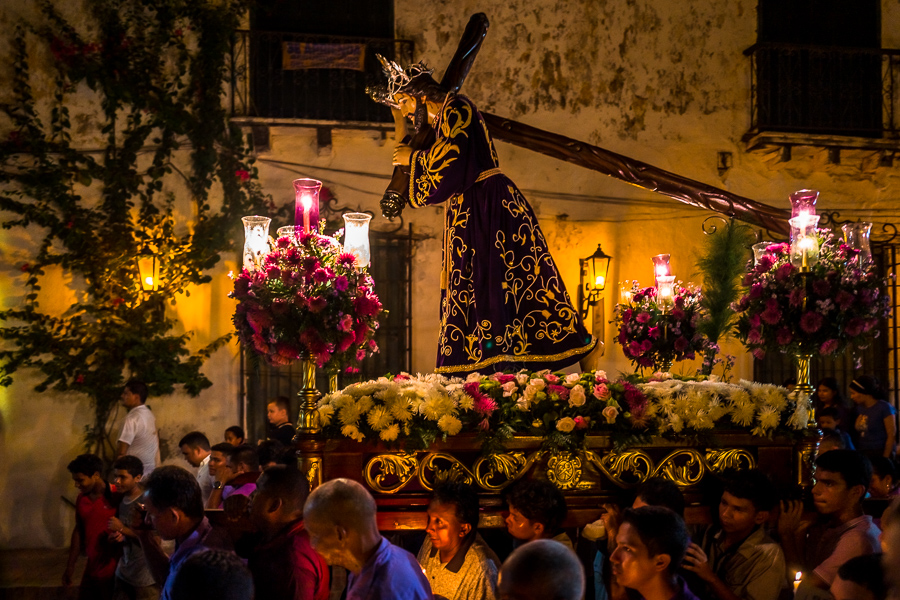 Catholic devotees, members of a religious brotherhood, carry a float (paso) depicting the Passion of Christ during the Holy Week procession in Mompox, Colombia.