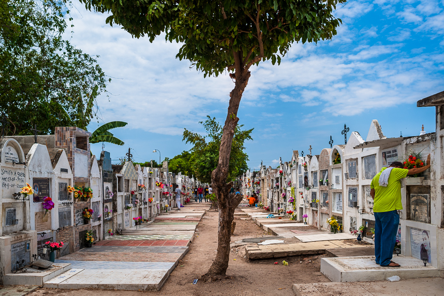 A Colombian man prays in front of a columbarium in remembrance of his deceased relatives during the Holy Week celebrations at the cemetery in Mompox, Colombia.