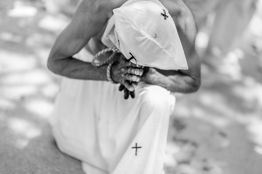 An Afro-Colombian man kneels while praying as part of the Holy Week religious procession in Santo Tomás, Colombia.