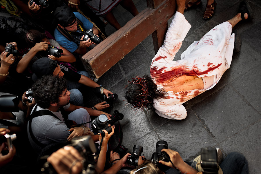 Photographers take pictures of a man representing Jesus Christ during the Holy Week celebration in Lima, Peru.