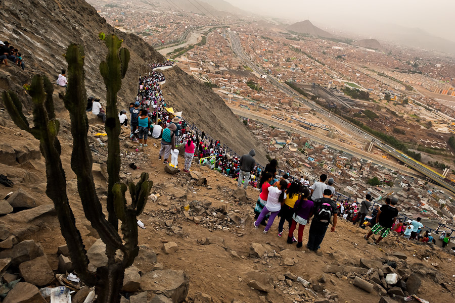 Crowds of catholic followers watch the Good Friday procession climbing the hill of San Cristobal during the Holy week in Lima, Peru.