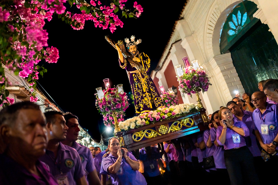 Catholic devotees, members of a religious brotherhood, carry a float (paso) depicting the Passion of Christ during the Holy Week procession in Mompox, Colombia.