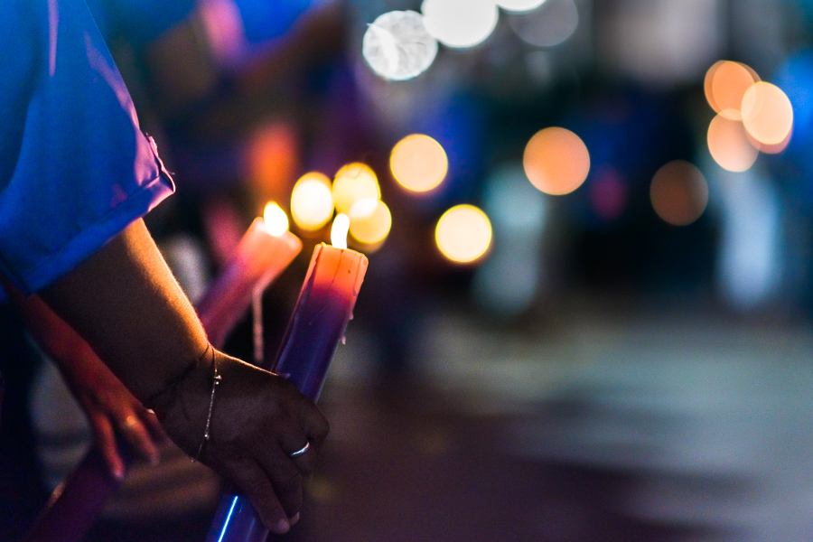 Catholic devotees, members of a religious brotherhood, hold lit candles as they march in a procession during the Holy Week celebrations in Mompox, Colombia.