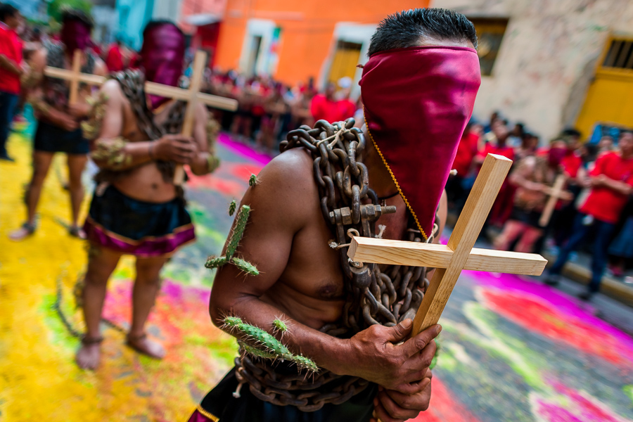 Chained Catholic devotees, wearing hoods and cactus spines stuck to their bodies, take part in the Holy week penitential procession in Atlixco, Mexico.