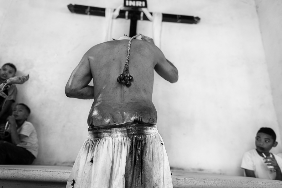 An Afro-Colombian man whips himself during a penance ritual as part of the Holy Week religious procession in Santo Tomás, Colombia.