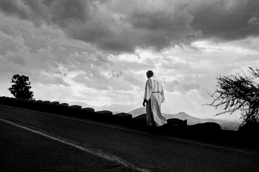 A Catholic priest walks up the road on the hill of San Cristóbal during the annual Holy Week procession in Santiago de Chile, Chile.