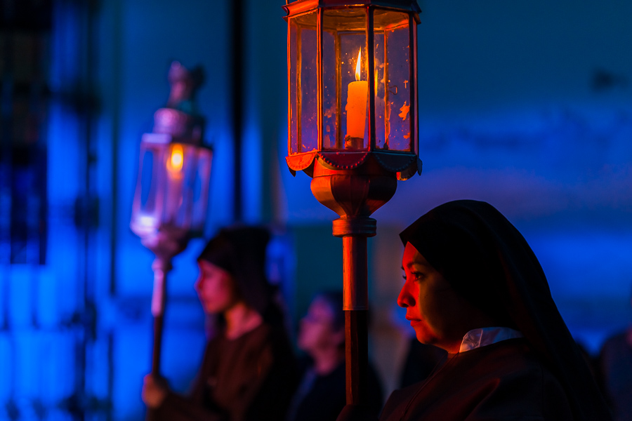 Catholic nuns, carrying procession lamps, walk in the Holy week penitential procession in Atlixco, Mexico.