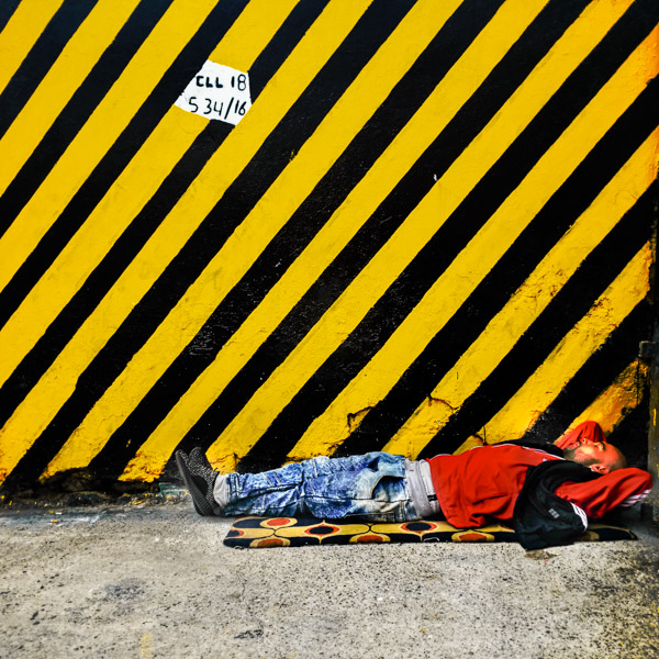 A Colombian homeless man sleeps on the street in the center of Bogotá, Colombia.