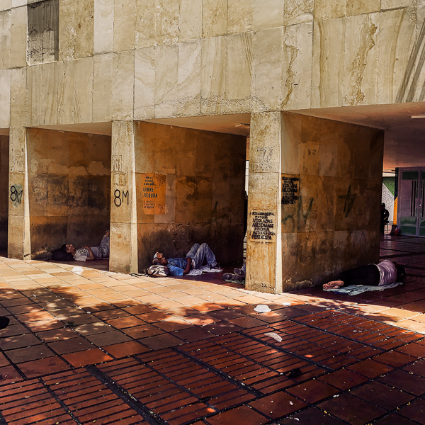 Homeless Colombian men sleep in the square in front of the Government of Valle del Cauca building in the center of Cali, Colombia.