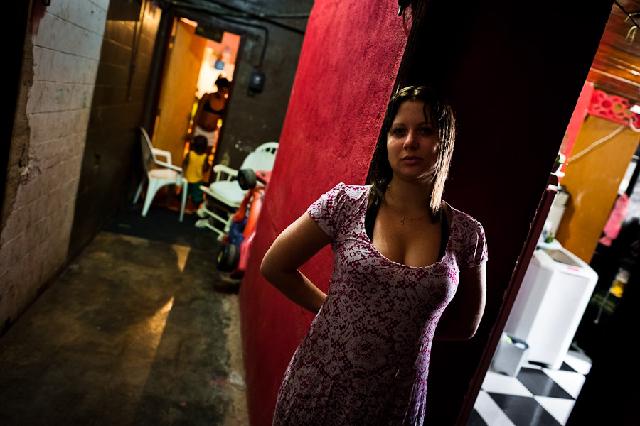 A Brazilian woman stands in the door of her apartment illegally built inside an abandoned factory in Rio de Janeiro, Brazil.