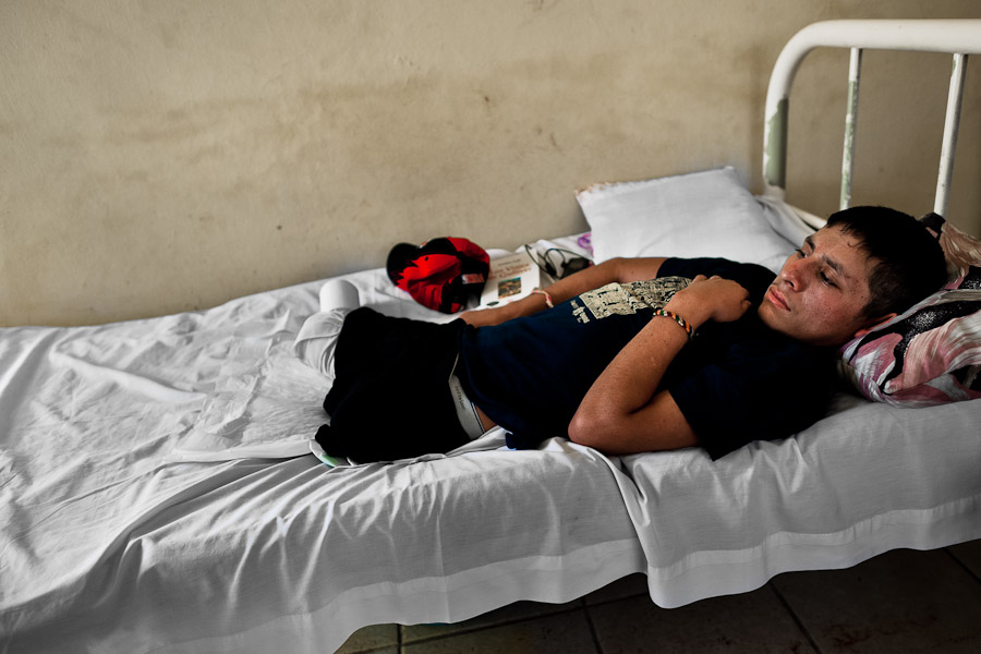 A 16-year-old Honduran immigrant, having both his legs amputated by a train during an attempt to get illegally to the US, lies on the bed in a refugee shelter in Tapachula, Mexico.