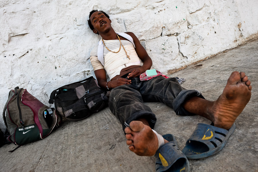 A Honduran immigrant waits to catch the cargo train called ‘La Bestia’ (The Beast) on a train station in a border town of Arriaga, Mexico.