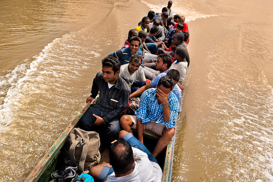 Nepalese and Somali immigrants, heading the southern U.S. border, travel on the canoe while crossing the jungle of Darien gap in Panama.