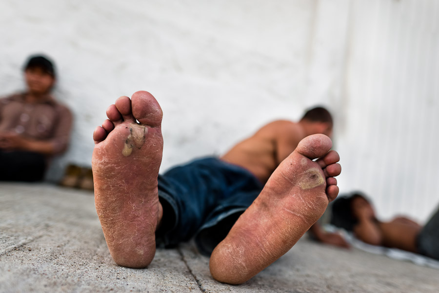 Young immigrants from El Salvador wait on a train station in Arriga, close to the Mexico-Guatemala border, to catch the cargo train called Train of Death.