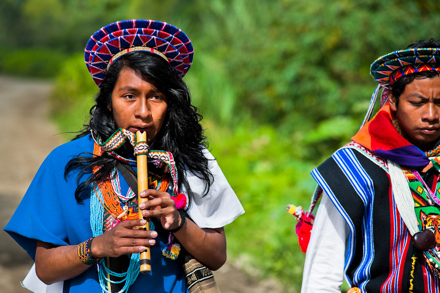 A native from the Kamentsá tribe, wearing a colorful headgear, plays flute during the Carnival of Forgiveness, a traditional indigenous celebration in Sibundoy, Colombia.
